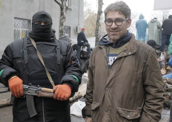 US reporter Simon Ostrovsky in Slovyansk earlier this month, along with a masked proRussia gunman. Picture: Efrem Lukatsky/AP