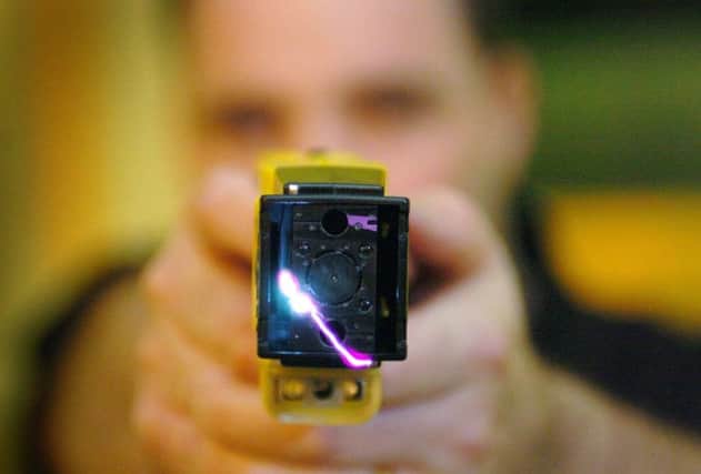 Stock image of a police officer demonstrating a Taser. Picture: PA