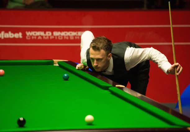 Judd Trump contemplates a tricky shot during his 108 firstround win over qualifier Tom Ford. Picture: Getty