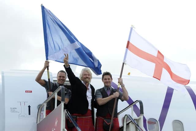 Sir Richard Branson disembarks from the inaugural Virgin Atlantic Little Red flight from London Heathrow to Edinburgh Airport. Picture: TSPL