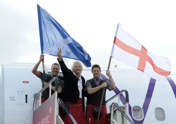 Sir Richard Branson disembarks from the inaugural Virgin Atlantic Little Red flight from London Heathrow to Edinburgh Airport. Picture: TSPL