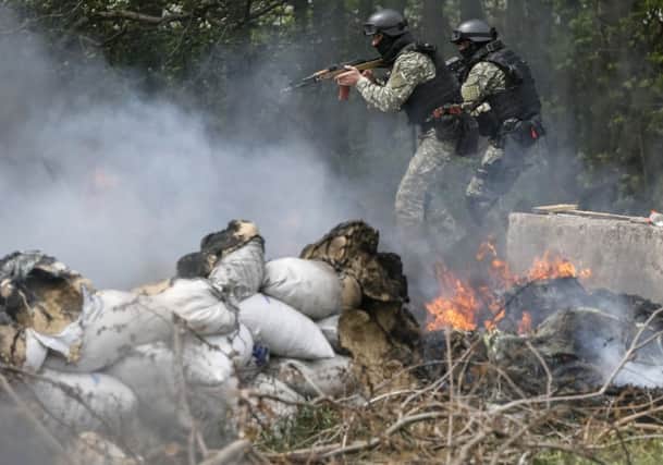Ukrainian security force officers are deployed at a checkpoint near Slaviansk. Picture: Reuters