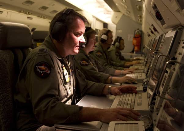 An Australian Defence Air Combat Officer searches for the missing plane. Picture: Getty