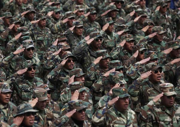 Indigenous soldiers salute and sing as they march through La Paz. Picture: AP