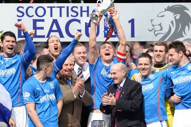 Rangers captain Lee McCulloch, centre, lifts the League One trophy after his team's 3-0 win over Stranraer. Picture: SNS
