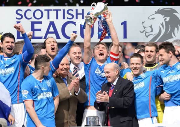 Rangers captain Lee McCulloch, centre, lifts the League One trophy after his team's 3-0 win over Stranraer. Picture: SNS