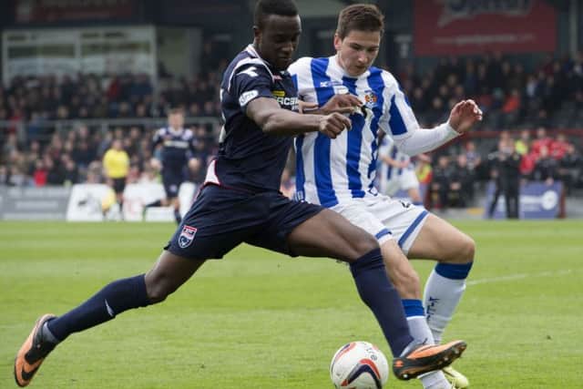 Ross County's Jordan Slew challenges Vitalijs Maksimenko. Picture: SNS