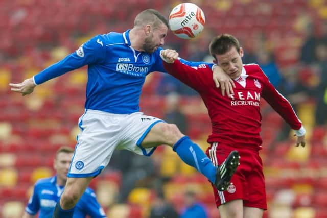 James Dunne, left, contests for the ball with Aberdeen's Peter Pawlett. Picture: SNS