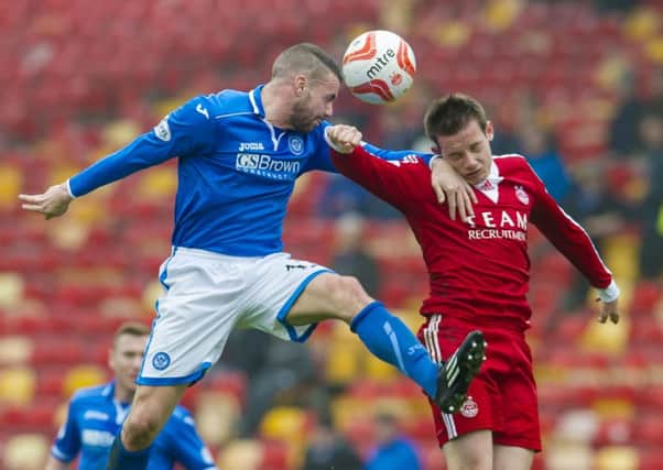 James Dunne, left, contests for the ball with Aberdeen's Peter Pawlett. Picture: SNS