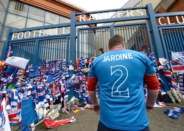 A Rangers fan wears a strip in tribute to Sandy Jardine before today's match. Picture: SNS