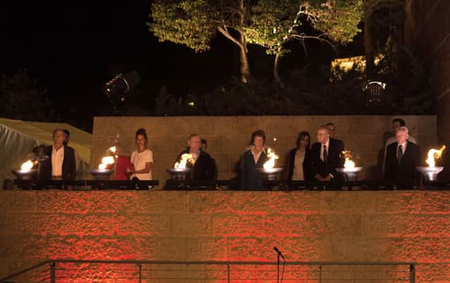 Holocaust survivors and their grandchildren light torches in memory of the victims at the Yad Vashem Holocaust memorial. Picture: Getty