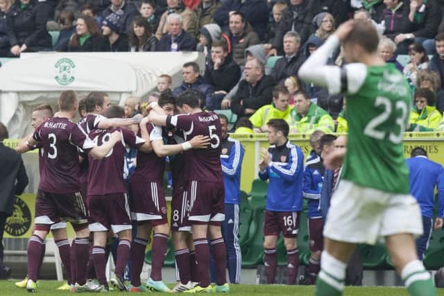 Bewilderment surrounds those in green and white as already-relegated Hearts celebrate their second goal. Picture: Toby Williams