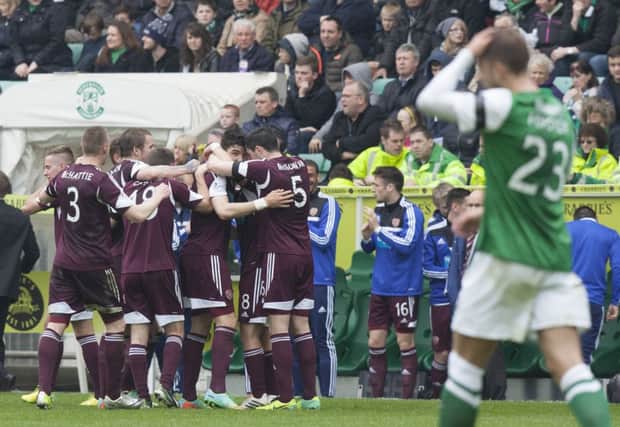 Bewilderment surrounds those in green and white as already-relegated Hearts celebrate their second goal. Picture: Toby Williams