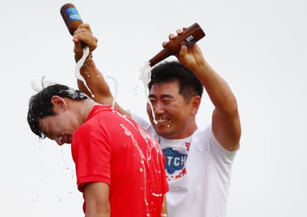 Noh Seung-yul is doused in beer by Yang Yong-eun after winning the Zurich Classic. Picture: Getty