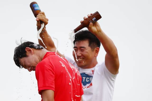 Noh Seung-yul is doused in beer by Yang Yong-eun after winning the Zurich Classic. Picture: Getty