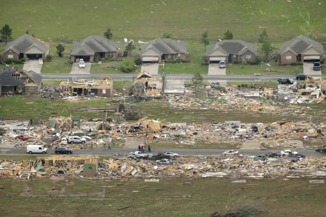 Two sides of the street reveal completely different outcomes for residents in this part of Arkansas. Picture: AP