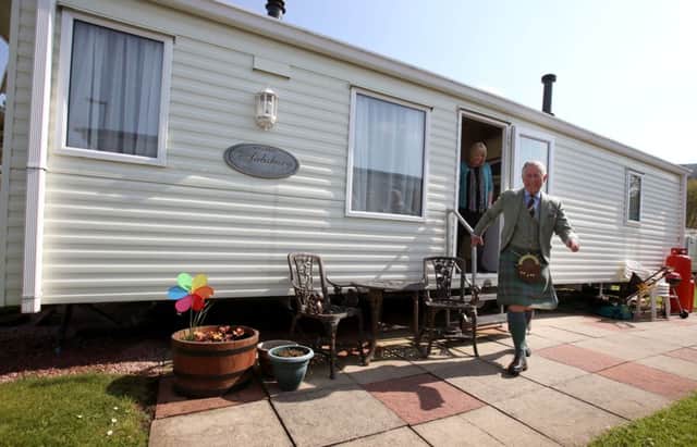 The Duke of Rothesay leaves Phyllis Stewart's caravan during a visit to Ballater Caravan Park. Picture: PA