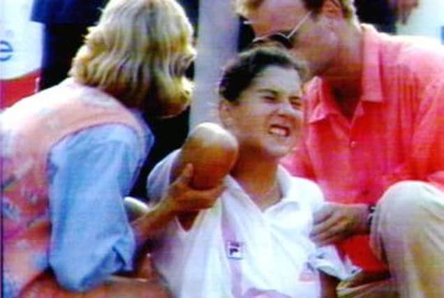 Tennis champion Monica Seles grimaces in pain after being stabbed on court by a spectator on this day in 1993. Picture: Getty