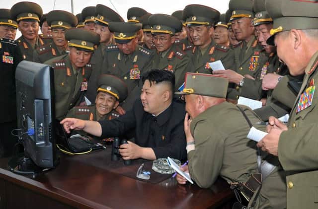 North Korean leader Kim Jong-un and military personnel at the test range. Picture: AFP/Getty