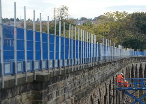 Workmen tend to the Newtongrange Viaduct, which will form part of the Borders Railway route. Picture: Neil Hanna
