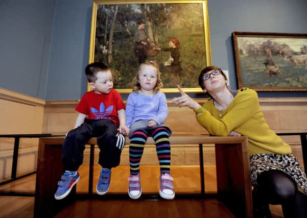 Nico Davie, 2, from Moodiesburn and Faith Fleming, also 2, from Falkirk get up close to the painting with museum curator Jo Meacock. Picture: John Devlin