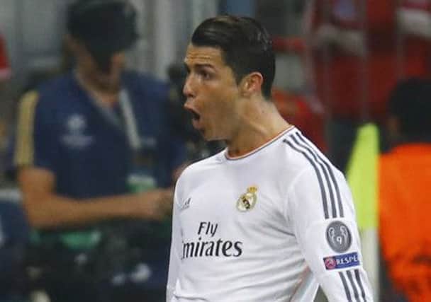 Cristiano Ronaldo celebrates scoring his second goal from a free kick. Picture: Kai Pfaffenbach/Reuters