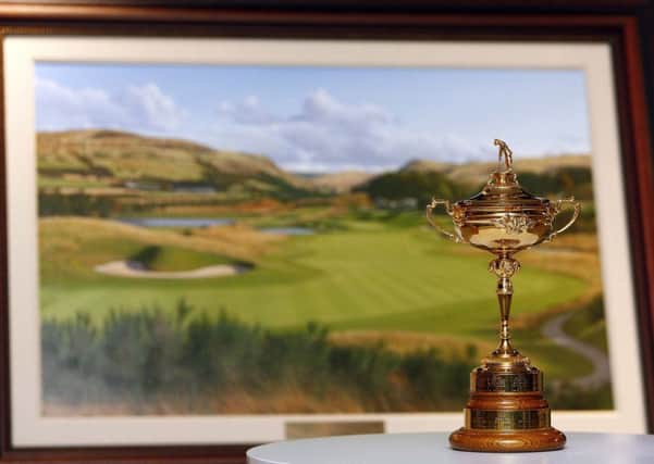 The Ryder Cup alongside the official painting of the 2014 tournament. Picture: PA