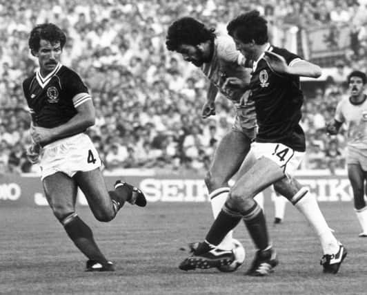 Brazils Socrates, left, and Scotlands David Narey in action in the 1982 World Cup. Picture: Getty