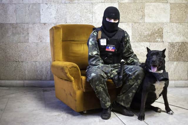 Pro-Russians, occupying the government headquarters in Donetsk, pose for portraits. Picture: Reuters