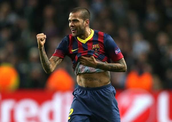 Barcelona's Dani Alves ate a banana thrown at him from the stands. Picture: PA