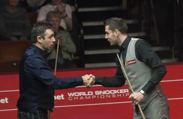 Alan McManus, left, congratulates Mark Selby on the win which ended the Scots Crucible run. Picture: PA