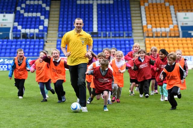 St Johnstone defender Dave Mackay joins young footballers as they take part in a special training day at McDiarmid Park. Picture: SNS
