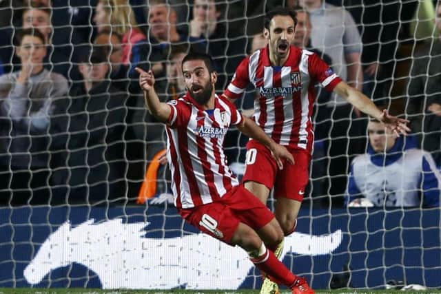 Arda Turan celebrates with Juanfran after scoring a goal against Chelsea. Picture: Reuters