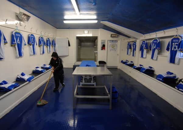 The Queen of the South changing room is given a once-over with a mop and bucket. Picture: Robert Perry