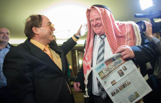 Mayor Ford dons Arab headdress as he campaigns last month. Picture: Getty