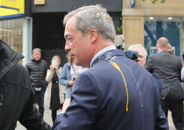 The egg struck Nigel Farage on his head and dribbled on to his shoulder, forcing him to cut short his walkabout. Picture: Getty