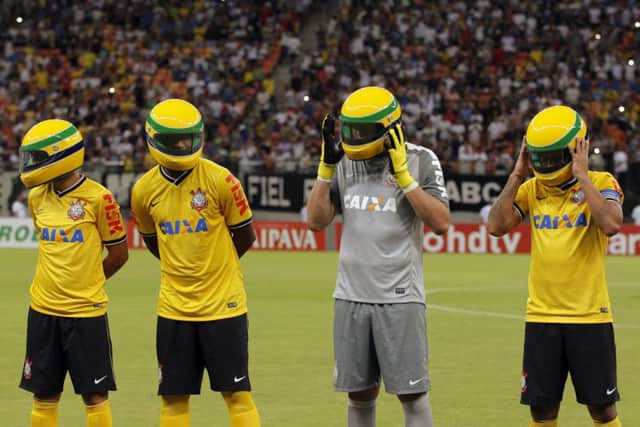 Corinthians players in replicas of the racing helmet worn by Ayrton Senna before their match against Nacional. Picture: Reuters
