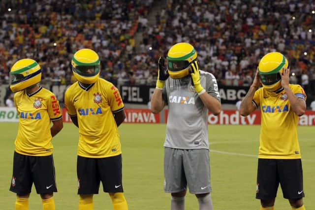 Corinthians players in replicas of the racing helmet worn by Ayrton Senna before their match against Nacional. Picture: Reuters