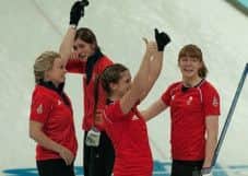 Claire Hamilton, right, and her teammates celebrate their Sochi Olympic bronze medal. Picture: Louise Kerr
