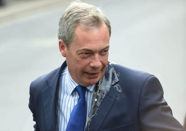 Egg dribbles down the jacket of UKIP leader Nigel Farage. Picture: PA