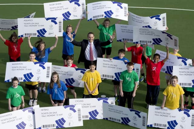 Glasgow 2014 Chief Executive David Grevemberg and students from the Glasgow School of Sport unveil the sale. Picture: SNS
