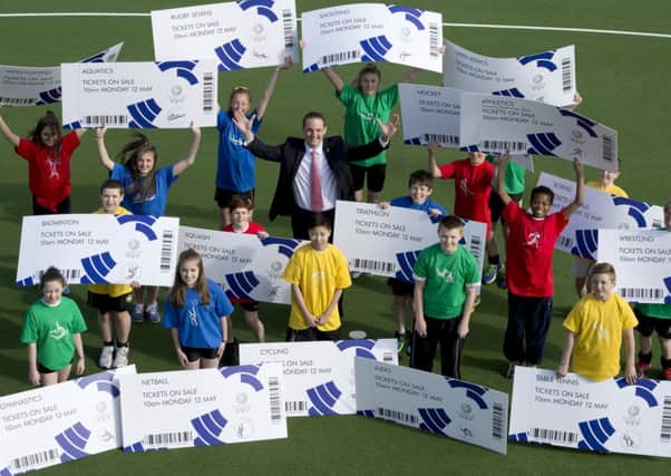 Glasgow 2014 Chief Executive David Grevemberg and students from the Glasgow School of Sport unveil the sale. Picture: SNS