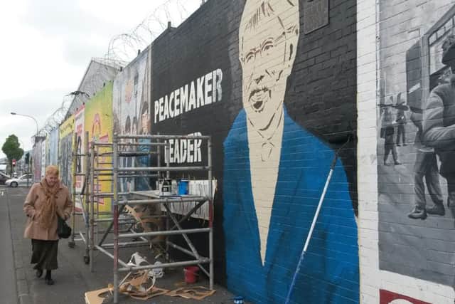 Work continues on a Gerry Adams mural in Belfast. Picture: PA