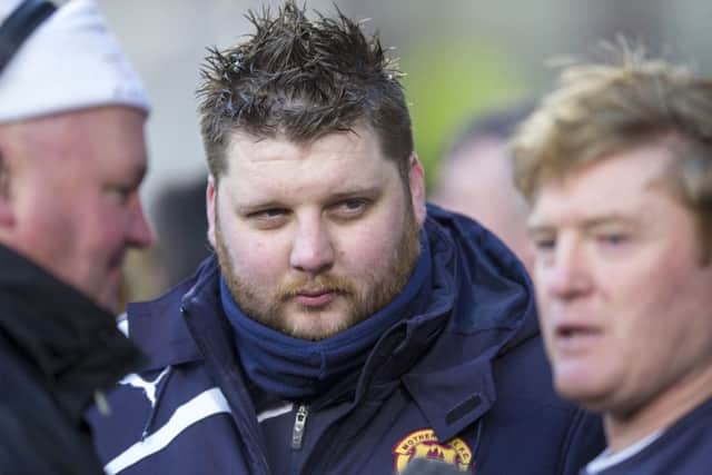 Alan Burrows keeps a close eye as Stuart McCall is interviewed by the BBC. Picture: PA