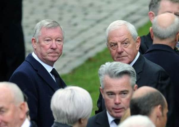 The funeral of former Hearts and Rangers player Sandy Jardine took place at Mortonhall, Edinburgh. Sir Alex Ferguson chats with Walter Smith OBE. Picture: TSPL