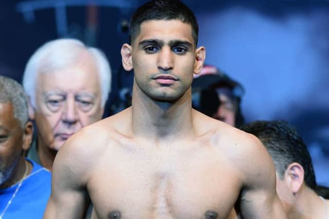Boxer Amir Khan poses on the scale during his official weigh-in at the MGM Grand Garden Arena on May 2, 2014 in Las Vegas, Nevada. Khan will meet Luis Collazo in a welterweight bout on May 3. Picture: Getty