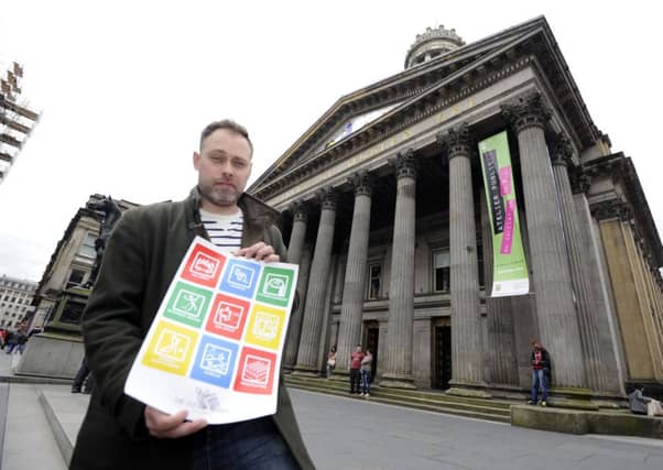 A member of the public holds the poster that has caused offence.Picture: TSPL