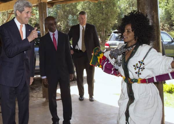 Kerry gives a thumbs-up to a local dancer before his speech at Gullele. Picture: Reuters