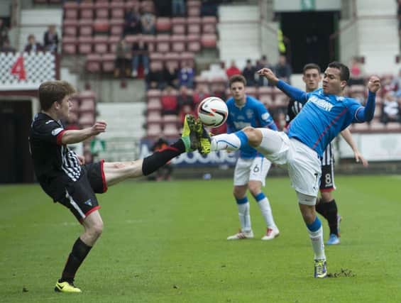 Dunfermline's Alex Whittle  battles for the ball with Arnold Peralta. Picture: SNS