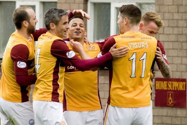 03/05/14 SCOTTISH PREMIERSHIP
MOTHERWELL v ST JOHNSTONE
FIR PARK - MOTHERWELL
Motherwell's Lionel Ainsworth (third from left) is swarmed by teammates after his goal.